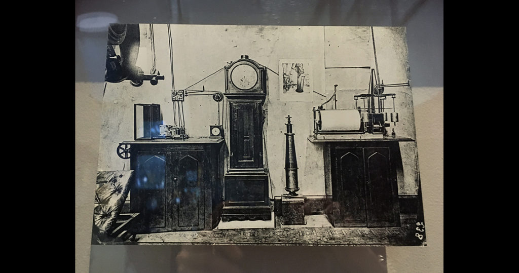 Black and white image of historical clocks and instruments